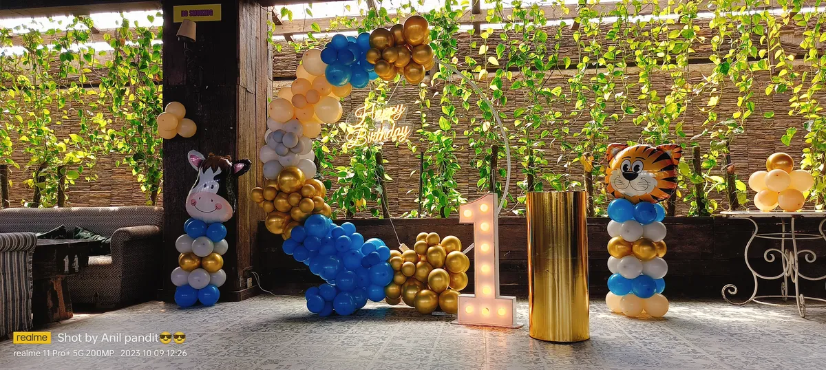 Minion theme birthday decoration with grass wall backdrop, Gurugram
