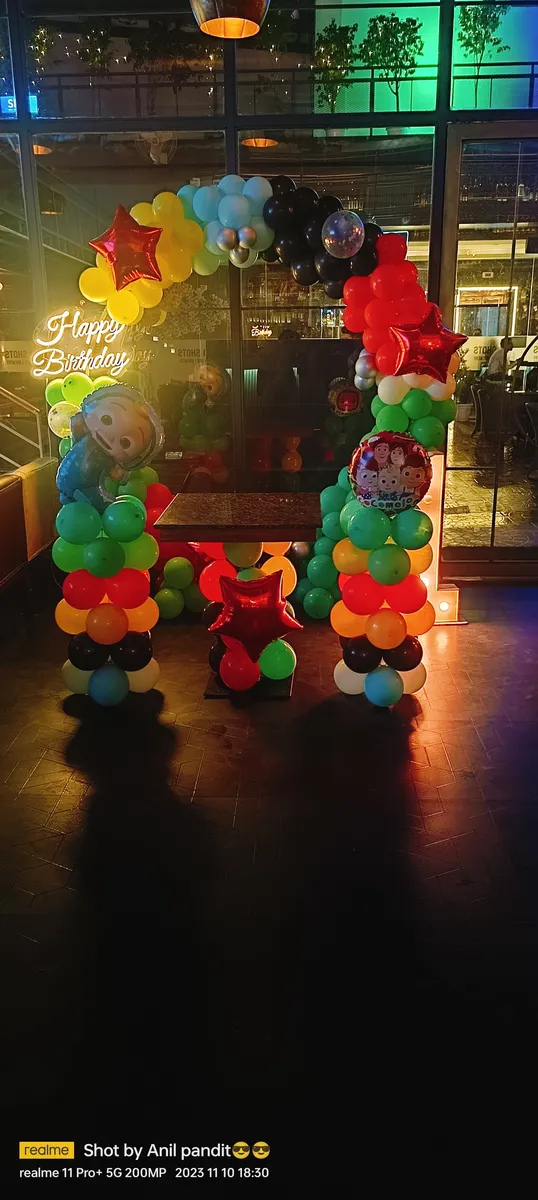Minion theme balloon arch decoration at night, Gurugram